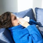 Woman in Blue Sweater Lying on Bed