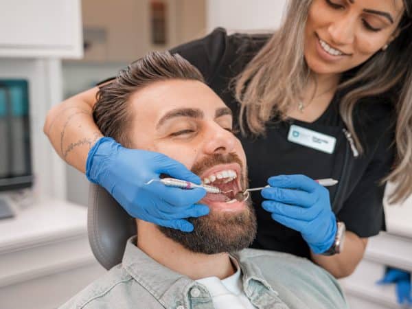 a person brushing a person's teeth