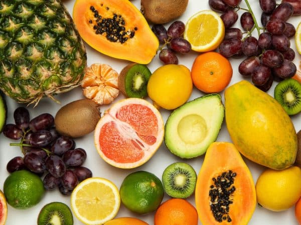 sliced orange fruit and green round fruits